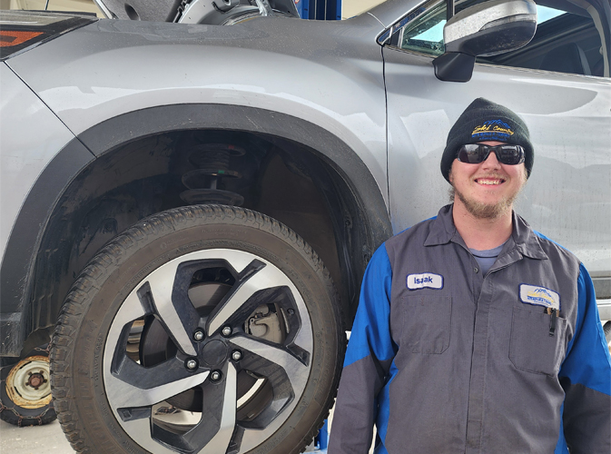 Staff Member In Front Of A Car | Ski Country Auto Repair and Towing